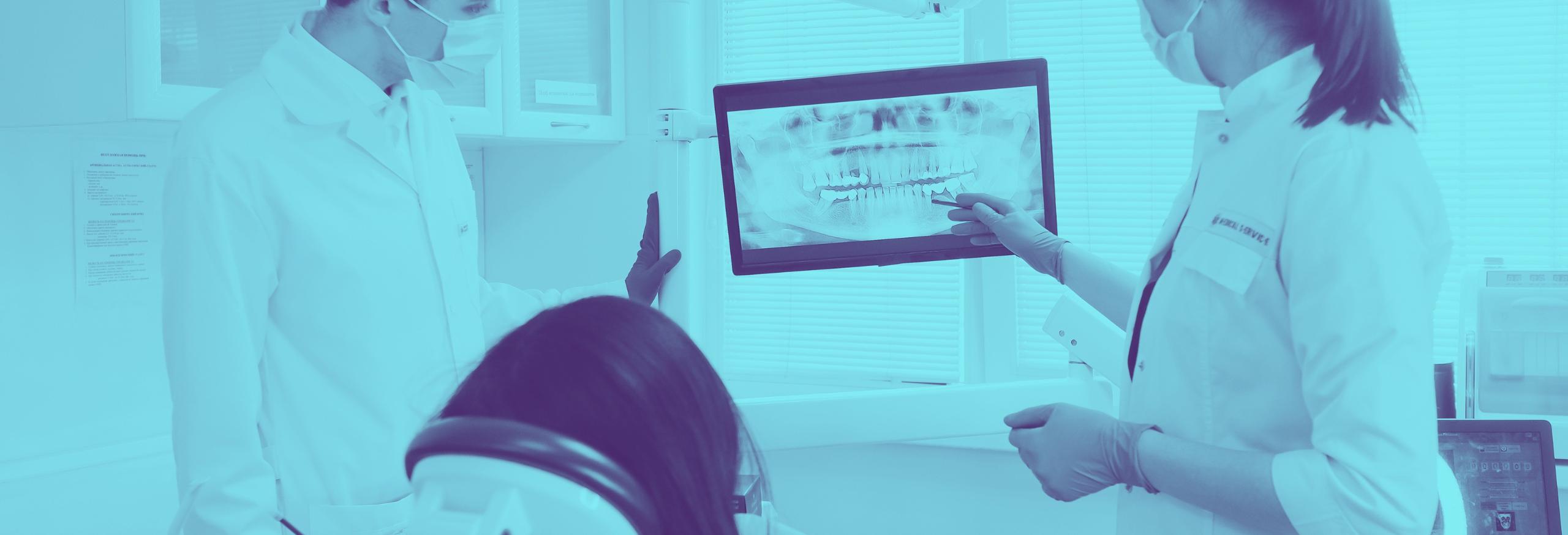 Dentists showing x-ray to a patient