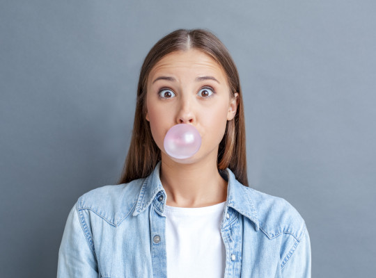 Woman blowing a bubble with gum