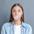 Woman blowing a bubble with gum