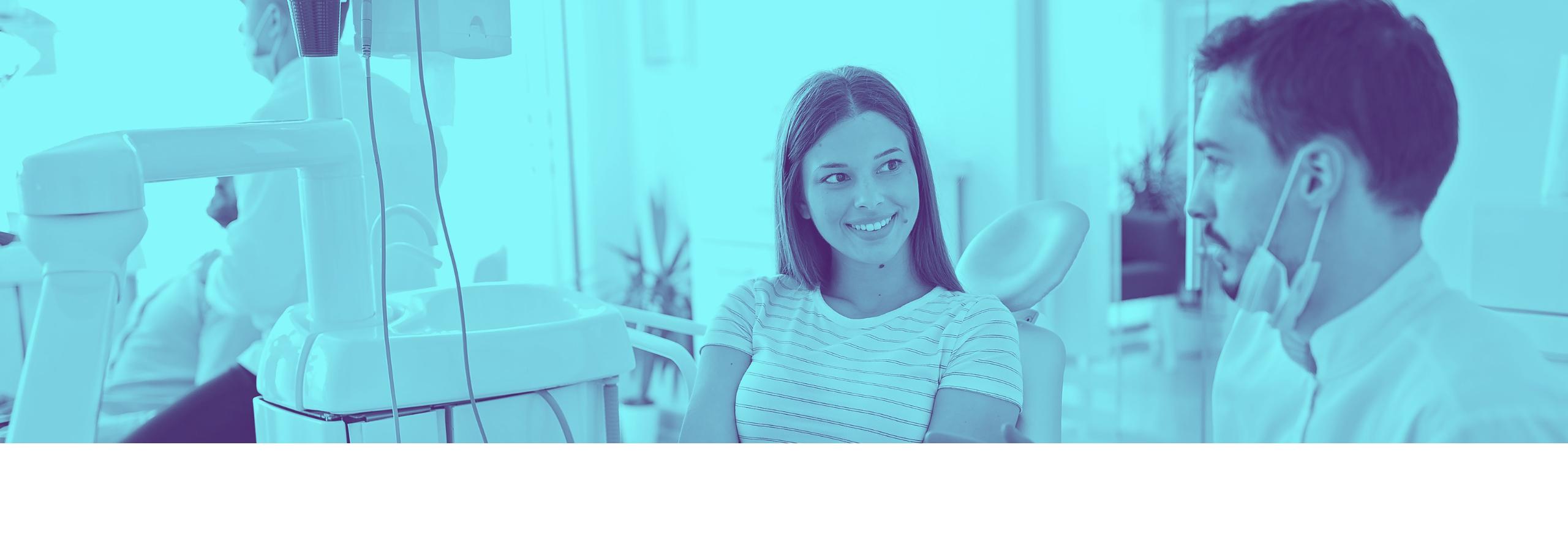 woman smiling and talking to a dentist