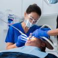 implant dentist performing a dental checkup