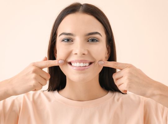 Girl pointing at her teeth
