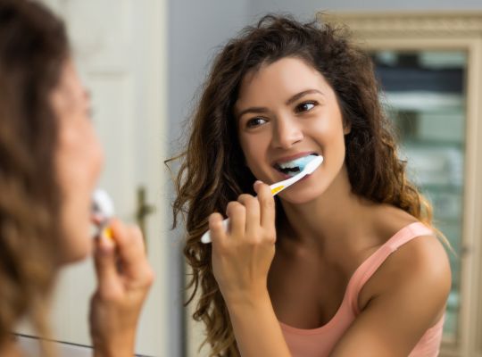 Woman brushing teeth